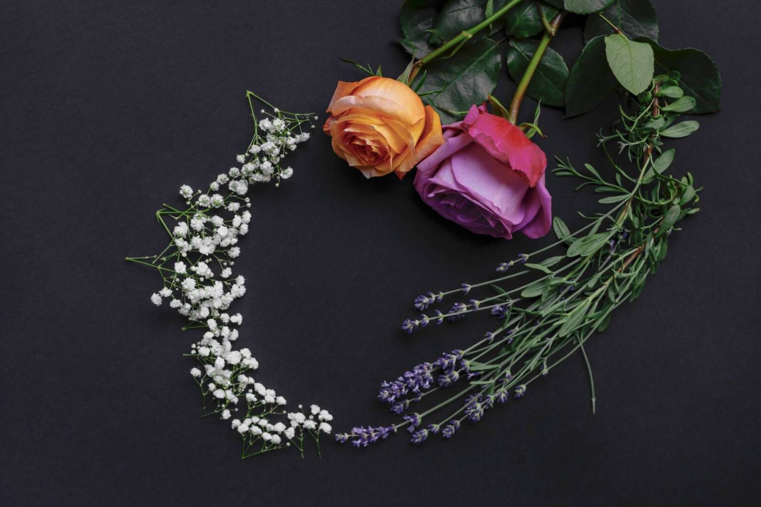 wreath-pattern-frame-made-fresh-flowers-black-background